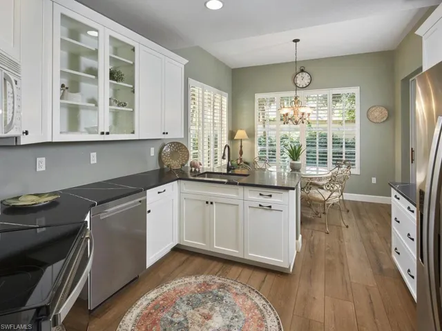 Kitchen featuring a peninsula, white cabinetry, stainless steel appliances, plenty of natural light, and recessed lighting