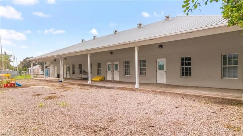 Back of property featuring a patio and a standing seam roof