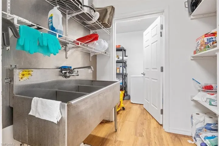 Laundry area with light wood-style floors
