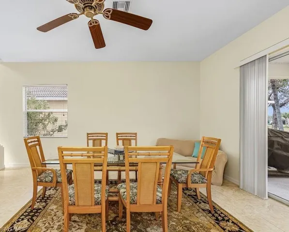 Dining space with a ceiling fan and baseboards