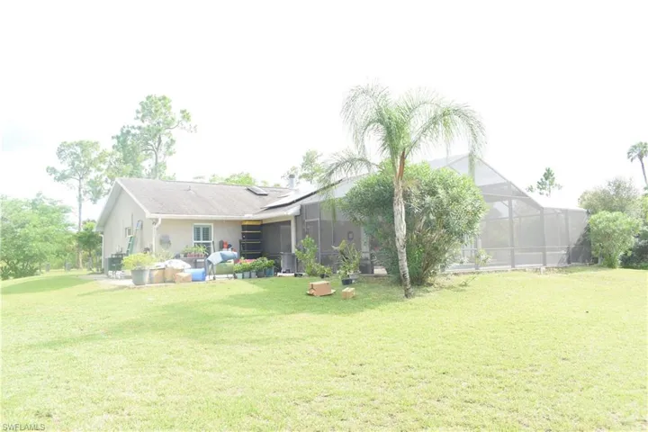 View of green lawn featuring a lanai