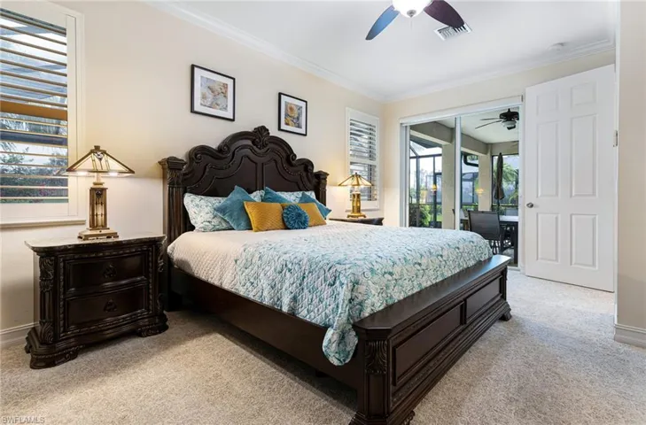 Bedroom with crown molding, new carpet, ceiling fan, and access to exterior