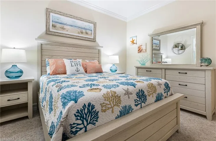 Guest bedroom featuring crown molding and new carpet
