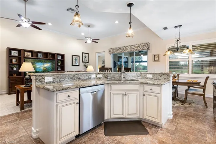 Kitchen island with granite countertops, decorative light fixtures, and Bosch stainless steel dishwasher