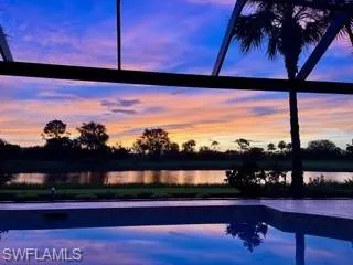 Pool at dusk with a water view