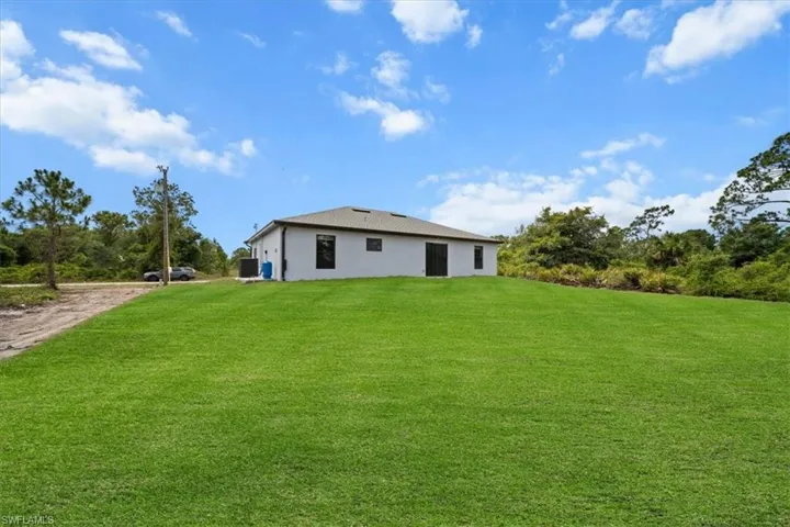 View of green lawn with driveway