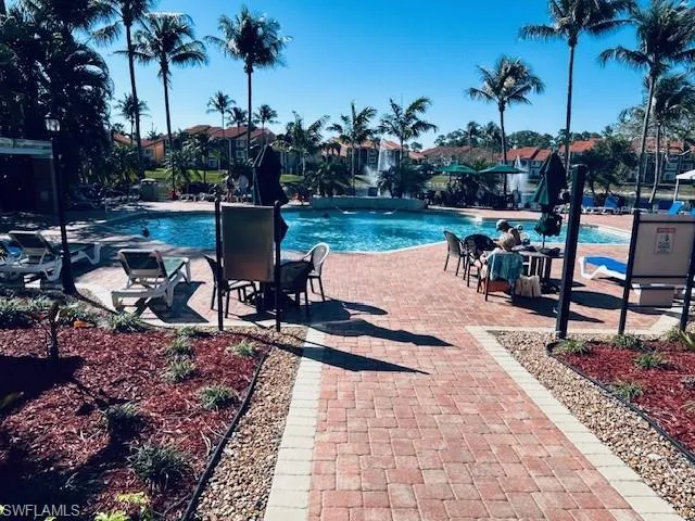 Community pool with a patio