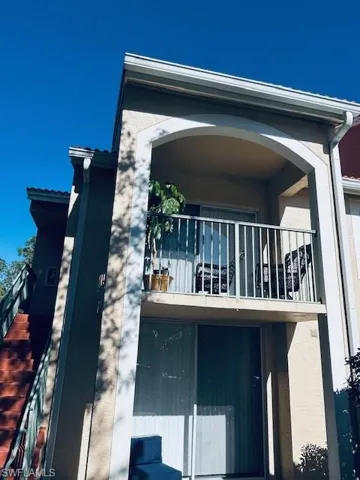 View of property exterior with a balcony and stucco siding