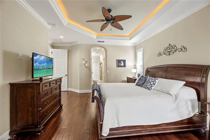 Master bedroom, arched doorway leads to master closets and en-suite bath