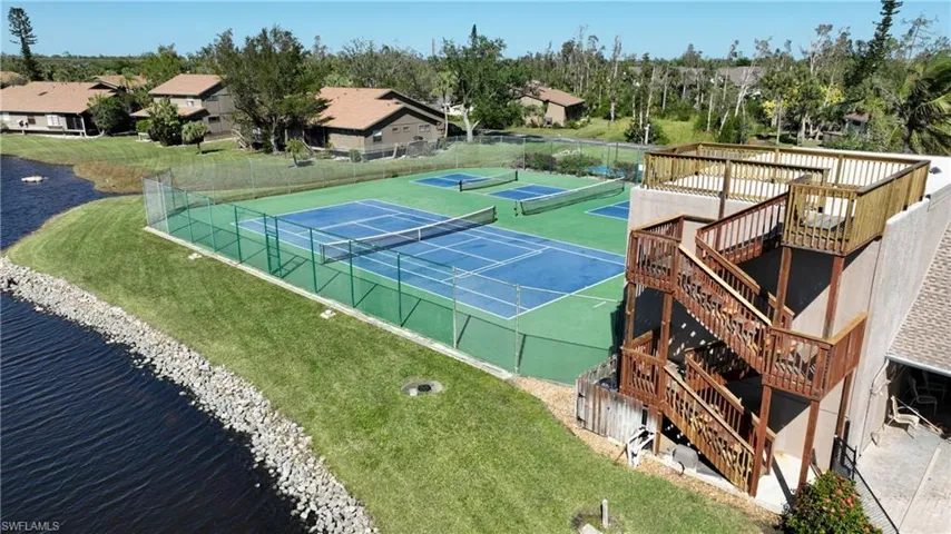Tennis and pickleball courts with a lookout tower and water view.