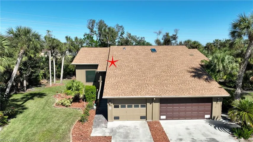 View of front of property side yard, New roof and a single car garage