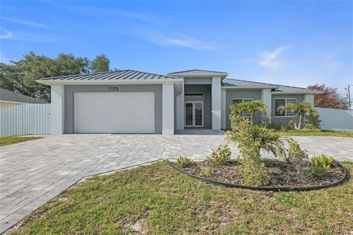 The property features a modern exterior with a light grey facade and a darker grey roof