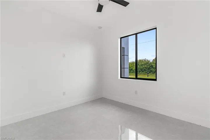 Empty room with baseboards and ceiling fan