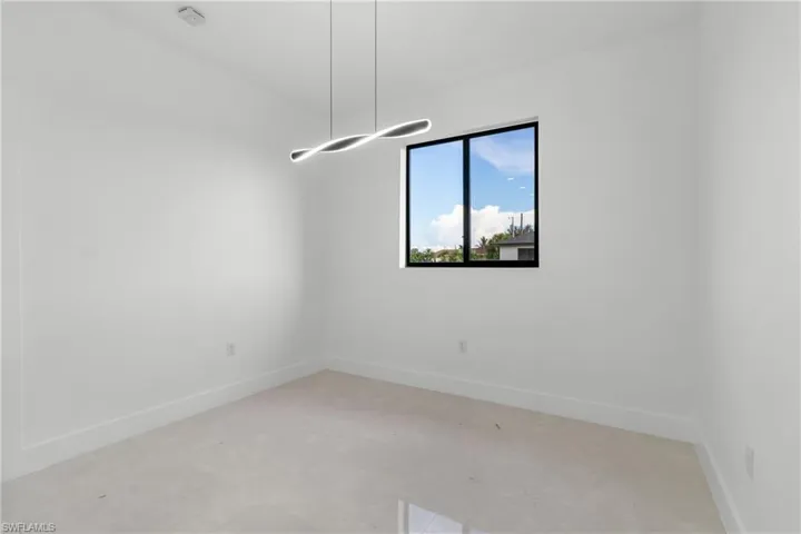 Spare room featuring baseboards