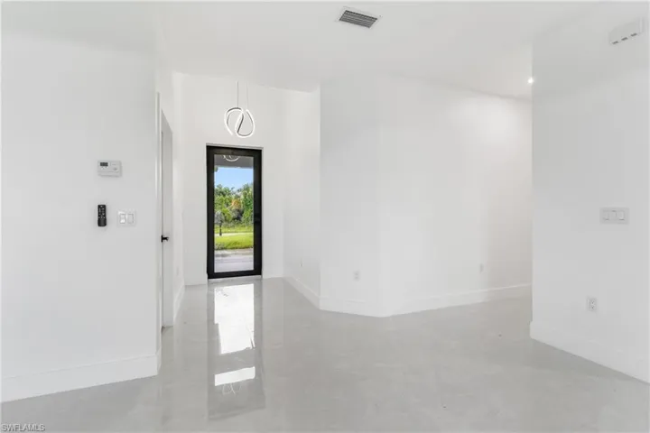 Foyer entrance featuring baseboards and finished concrete flooring