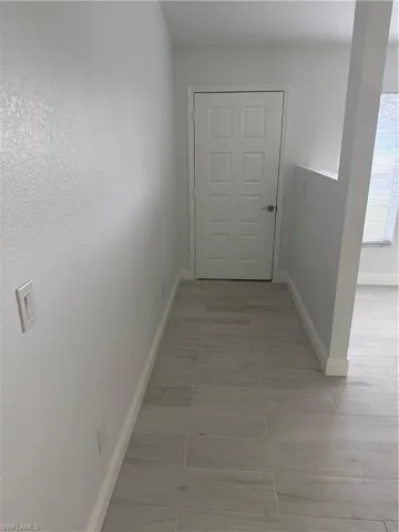 Hallway featuring baseboards