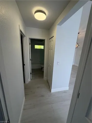 Hallway featuring baseboards