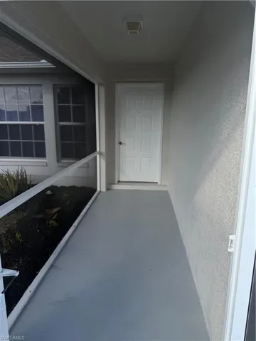 Doorway to property with stucco siding
