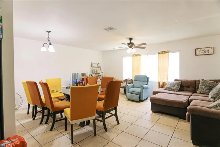 Dining space featuring light tile patterned flooring and ceiling fan