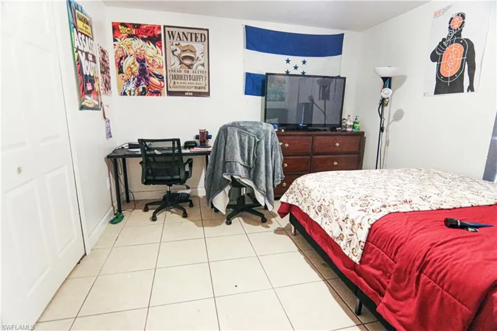 Bedroom featuring tile patterned flooring and a desk
