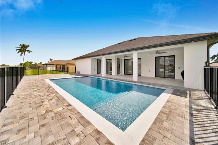 View of swimming pool with a patio and ceiling fan