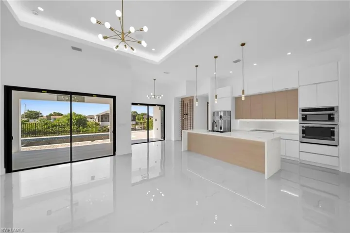 Kitchen featuring hanging light fixtures, light tile patterned floors, and a spacious island