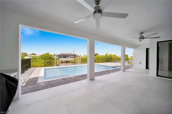 View of pool featuring ceiling fan, area for grilling, and a patio area