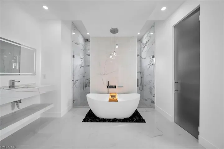 Bathroom featuring dual vanity, shower with separate bathtub, and tile patterned flooring