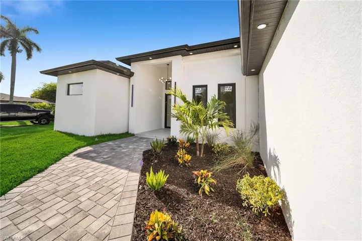 Doorway to property with a lawn