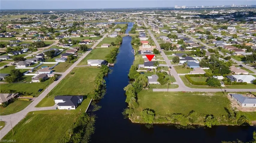 Birds eye view of property with a water view