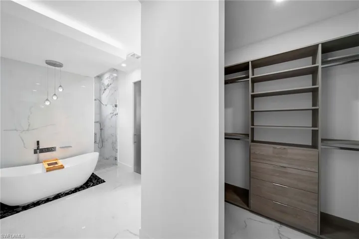 Bathroom featuring tile patterned flooring and a tile shower