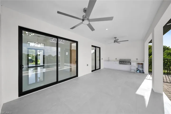 View of patio / terrace featuring area for grilling and ceiling fan