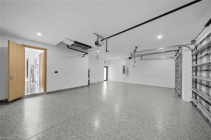 Garage with a garage door opener and electric panel