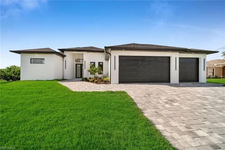 Prairie-style home featuring a garage and a front lawn