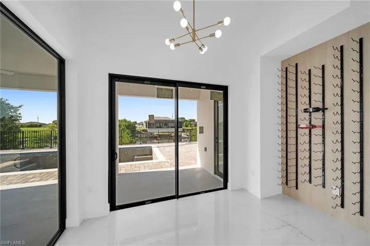 Doorway to outside with tile patterned floors and a chandelier