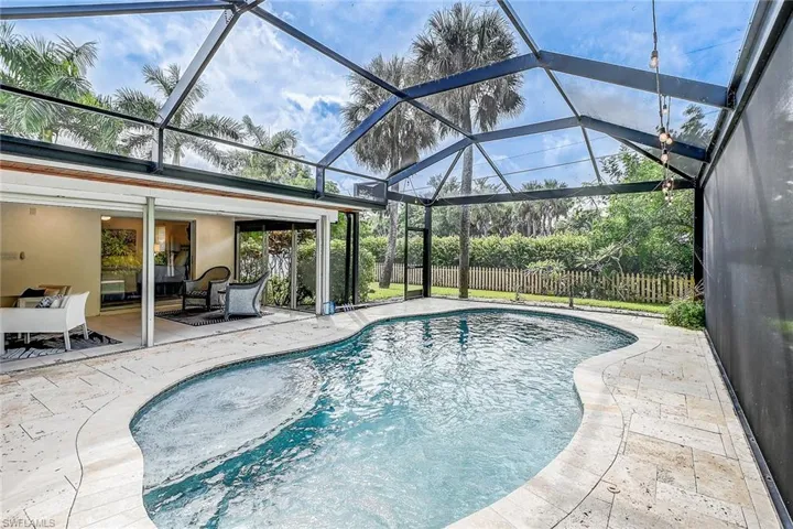 View of pool with a lanai and a patio area