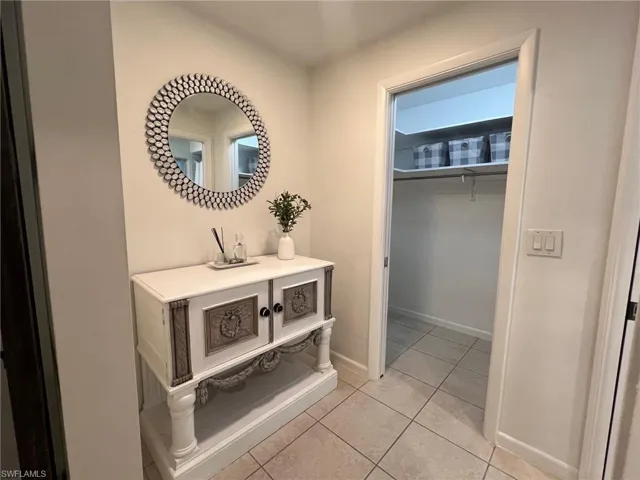 Corridor with light tile patterned floors