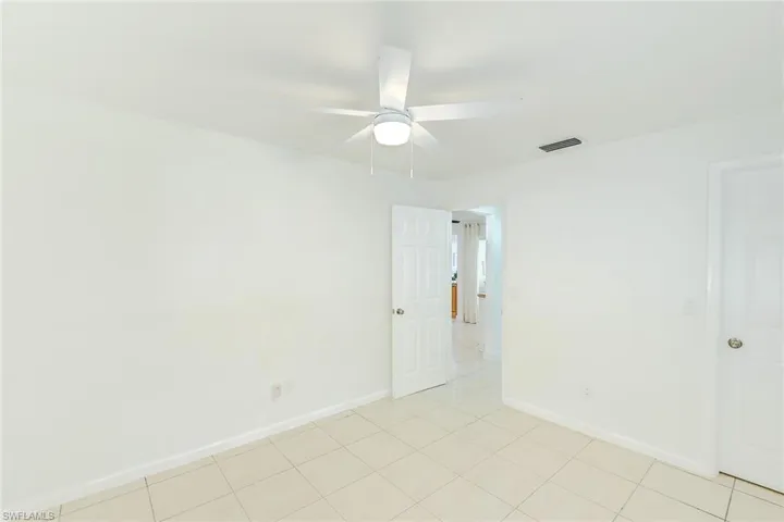 Unfurnished room featuring ceiling fan and light tile patterned floors