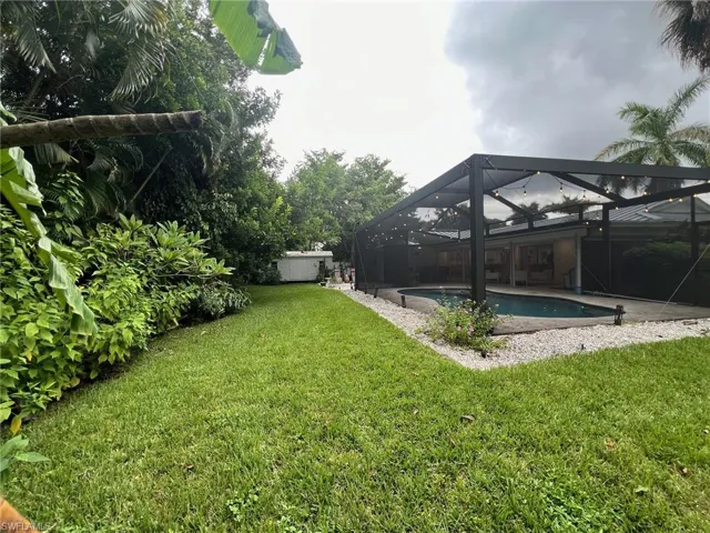 View of yard featuring glass enclosure