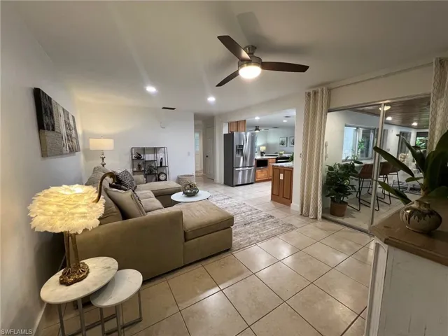 Tiled living room featuring ceiling fan