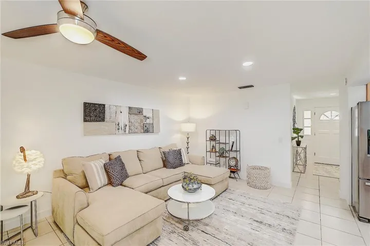 Living room featuring ceiling fan and light tile patterned floors