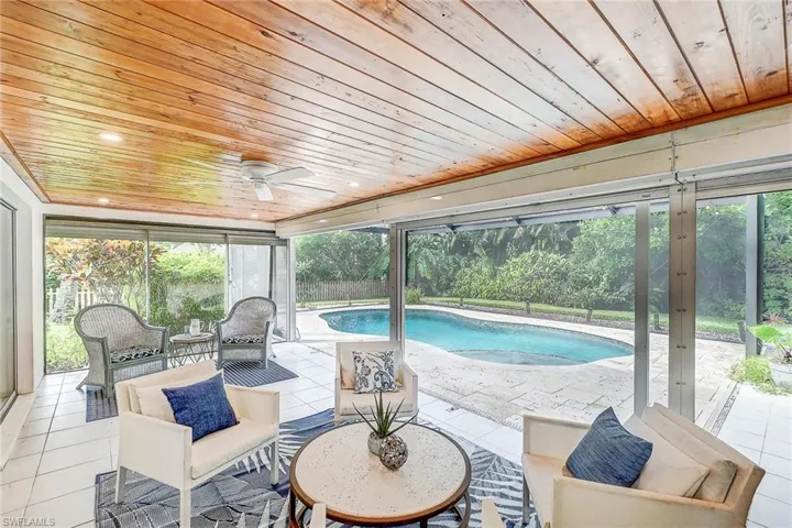 View of swimming pool with a patio, ceiling fan, and outdoor lounge area
