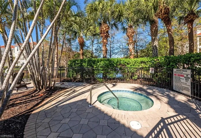 View of swimming pool with a patio area and a hot tub