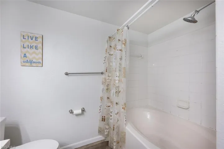 Bathroom with shower / bath combo and toilet