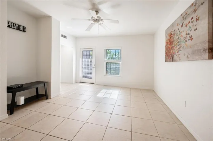 Tiled empty room with ceiling fan