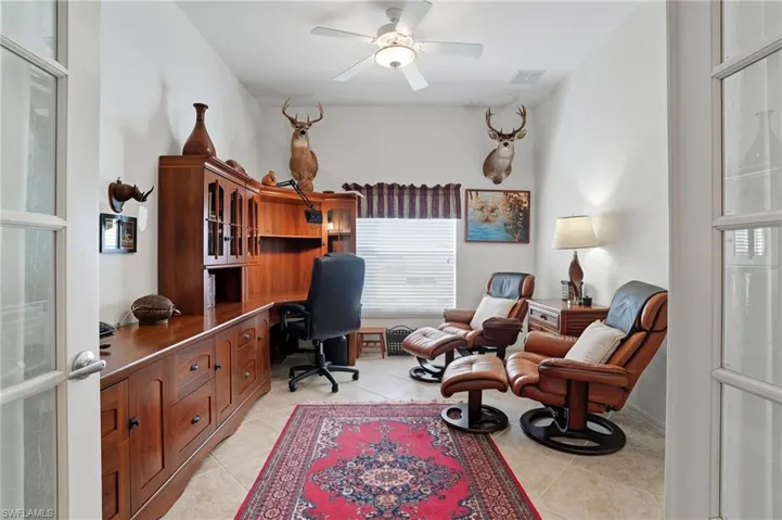 Office with ceiling fan, light tile patterned flooring, and french doors