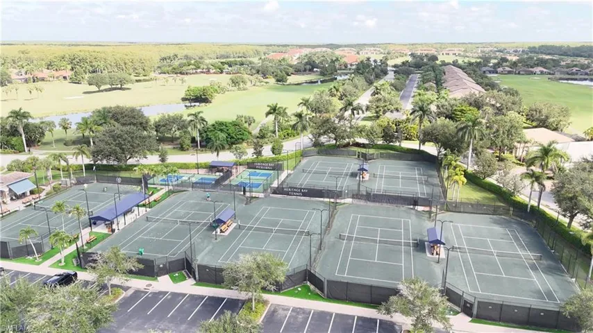 Aerial view of property's location with a golf club and a nearby body of water