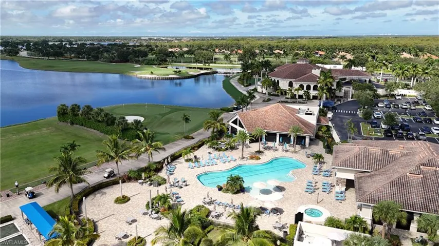 Aerial view of property and surrounding area featuring a large body of water and a golf club