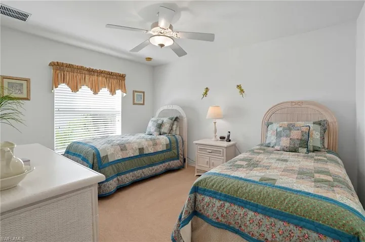 Bedroom featuring light carpet and ceiling fan