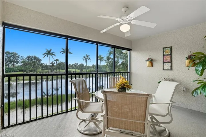 Sunroom / solarium featuring a water view